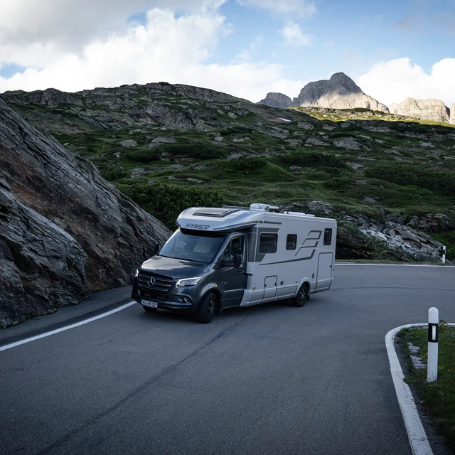 HYMER B-MasterLine T driving uphill on a rock-lined serpentine road