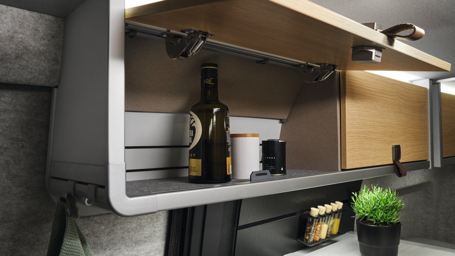 The modern look of the interior is underlined by the faux leather details, such as the handles on the overhead lockers.