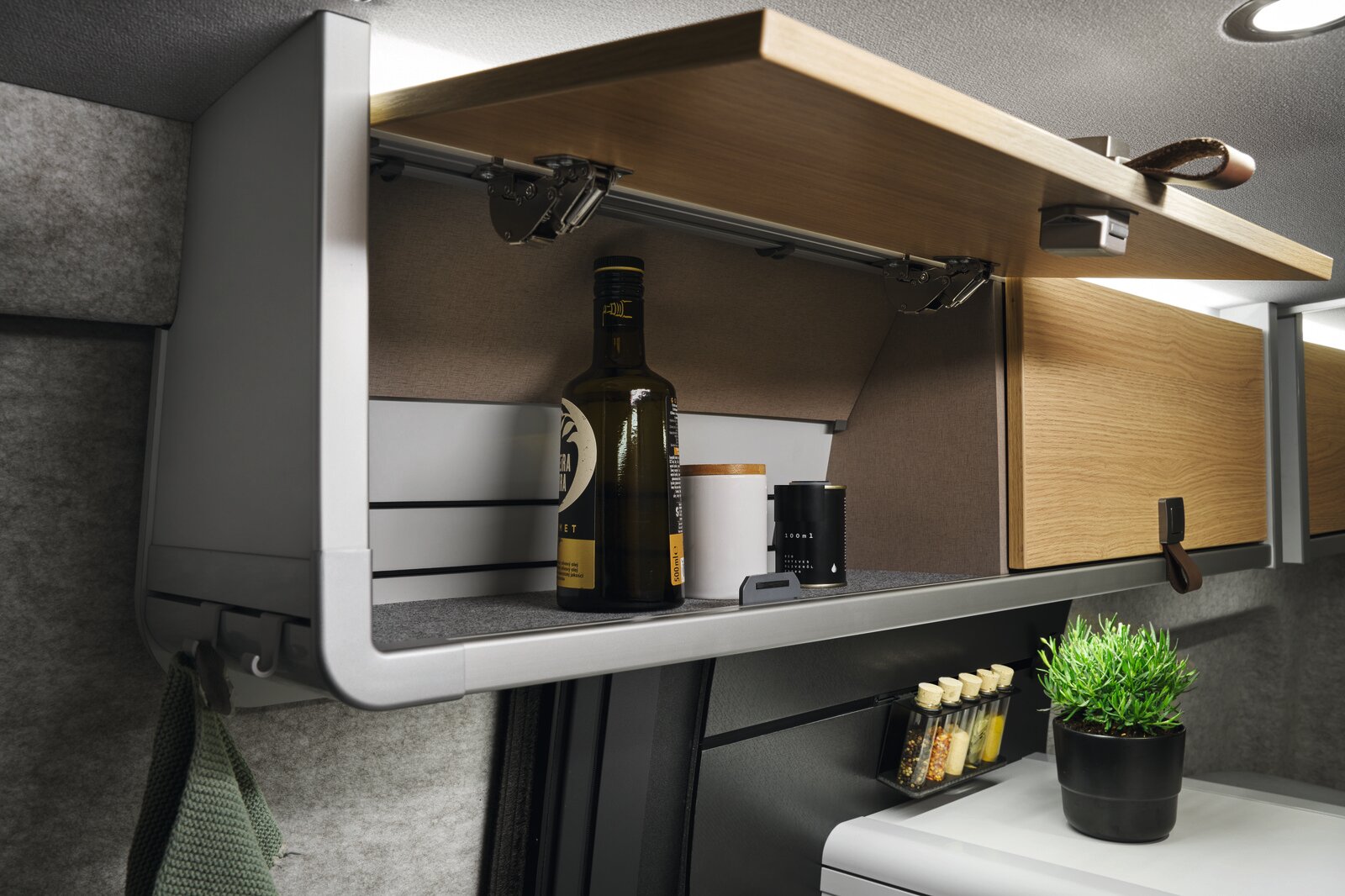 The modern look of the interior is underlined by the faux leather details, such as the handles on the overhead lockers.