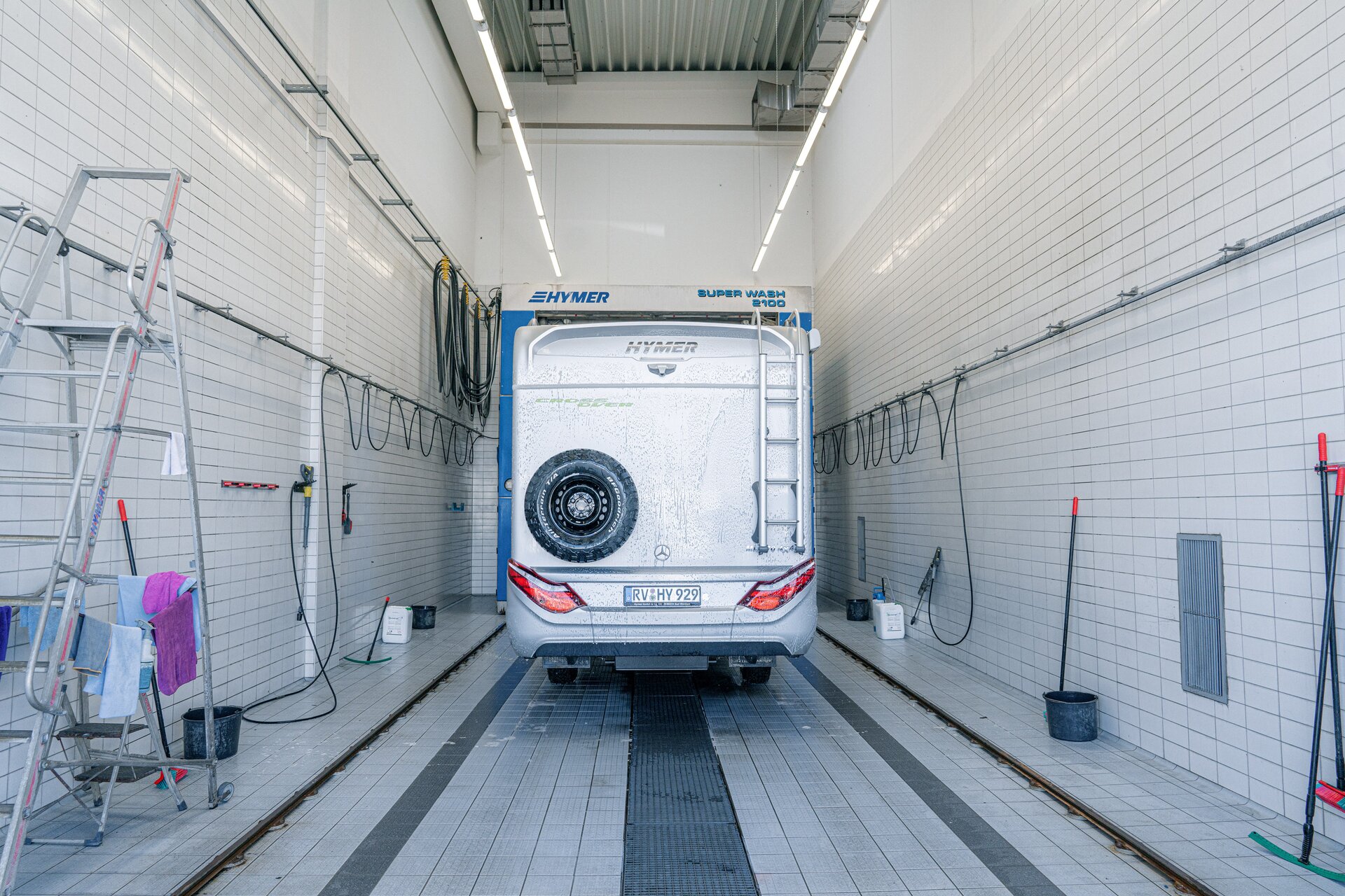 Rear view of the HYMER motorhome with spare wheel on back in the wash hall